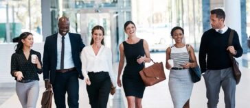 Shot of a group of confident businesspeople walking next to each other in a straight line at the office during the day